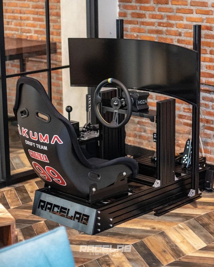 Complete sim racing cockpit with triple monitors, wheel, and pedals
